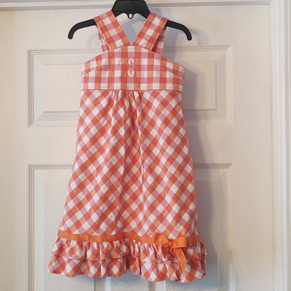 Little girls dress with "E" embroidered on front.